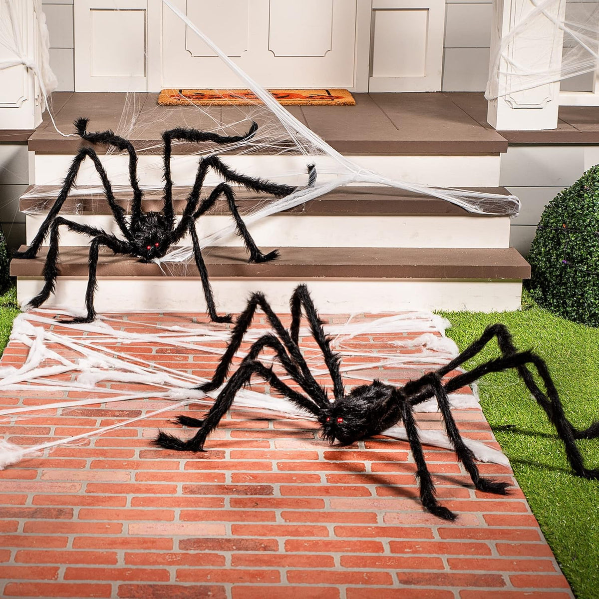 Giant Halloween spiders displayed on outdoor lawn