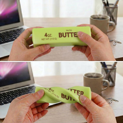 Two green butter-shaped squishy fidget toys with realistic food-inspired design