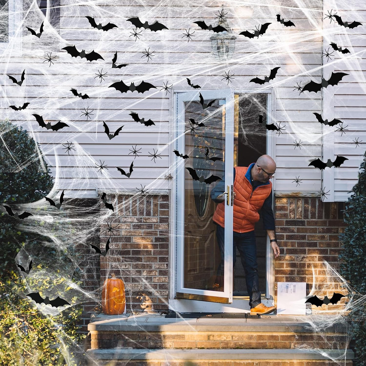 Black bat decorations displayed on Halloween spider webs
