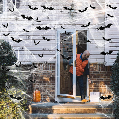 Black bat decorations displayed on Halloween spider webs