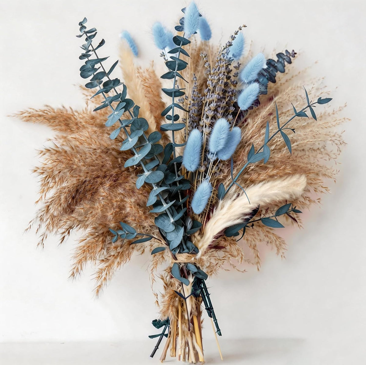 Boho dried flower arrangement in dusty blue and beige tones for home decor