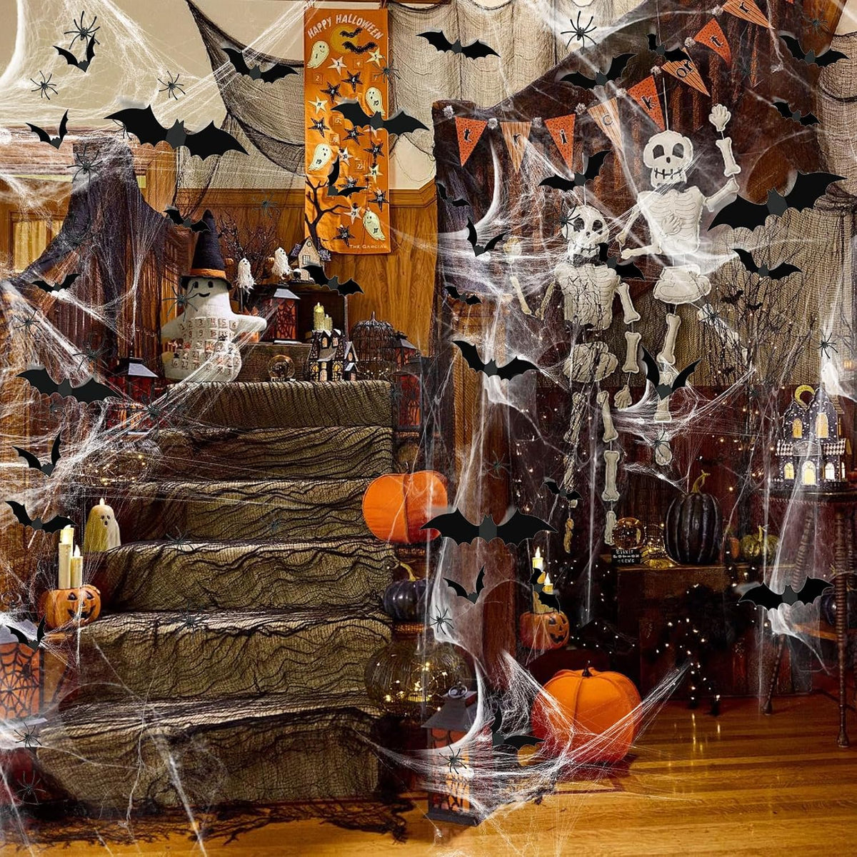 Fake bats and spiders arranged with Halloween spider web