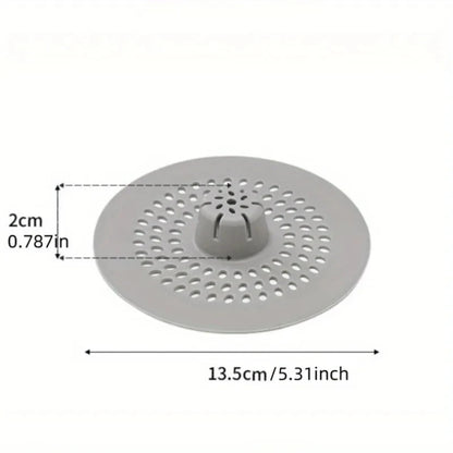 Silicone hair catcher over bathtub drain