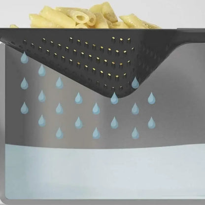 Slotted skimmer lifting fried food from oil