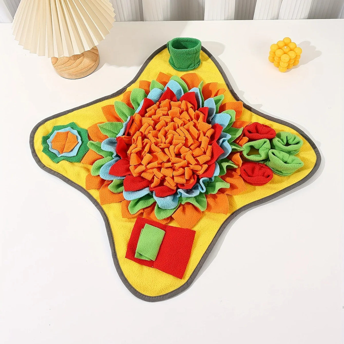 Dog sniffing for treats in a snuffle mat
